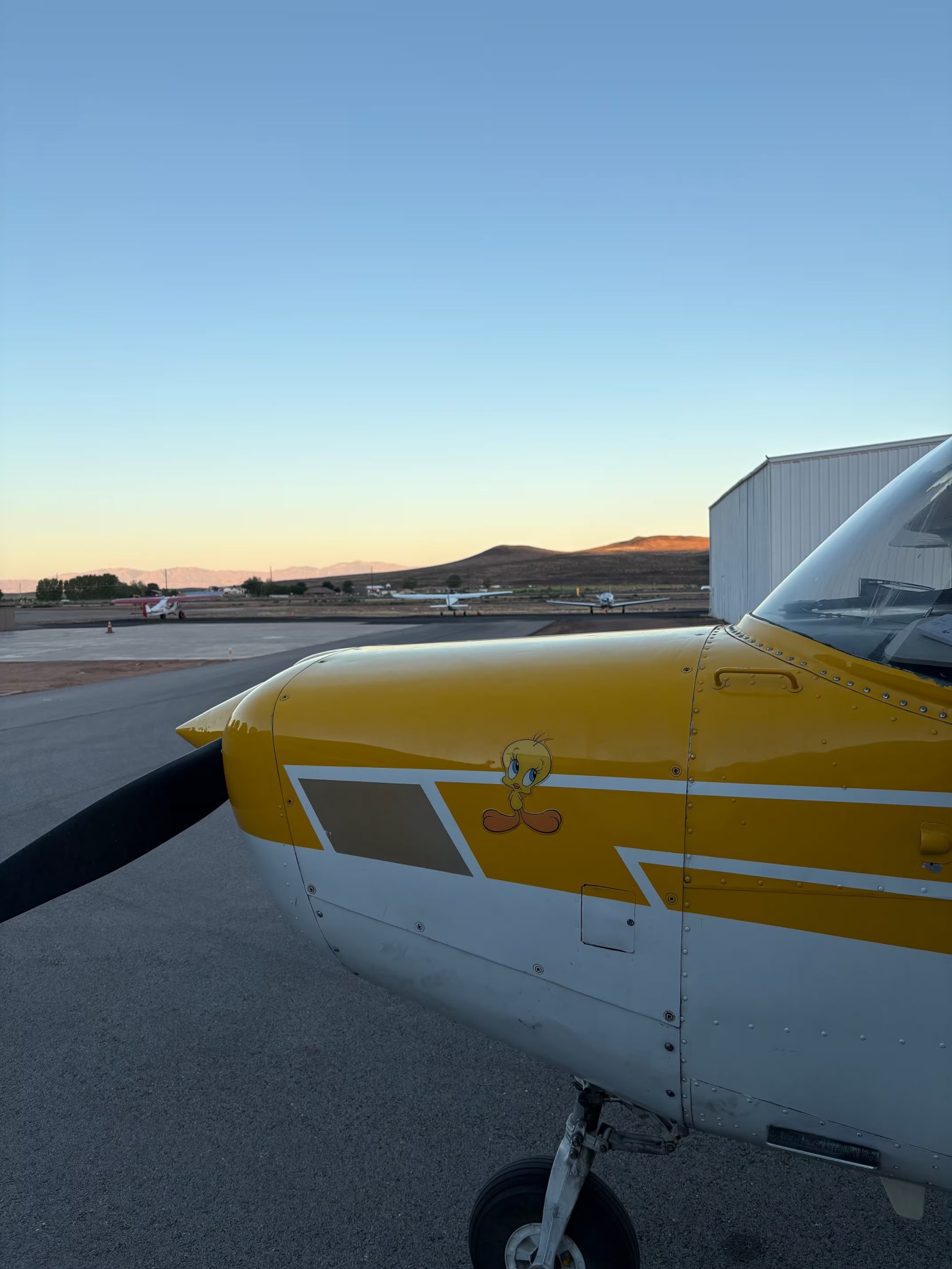 Tweety, the yellow and white Cessna 152, on the ramp at sunrise
